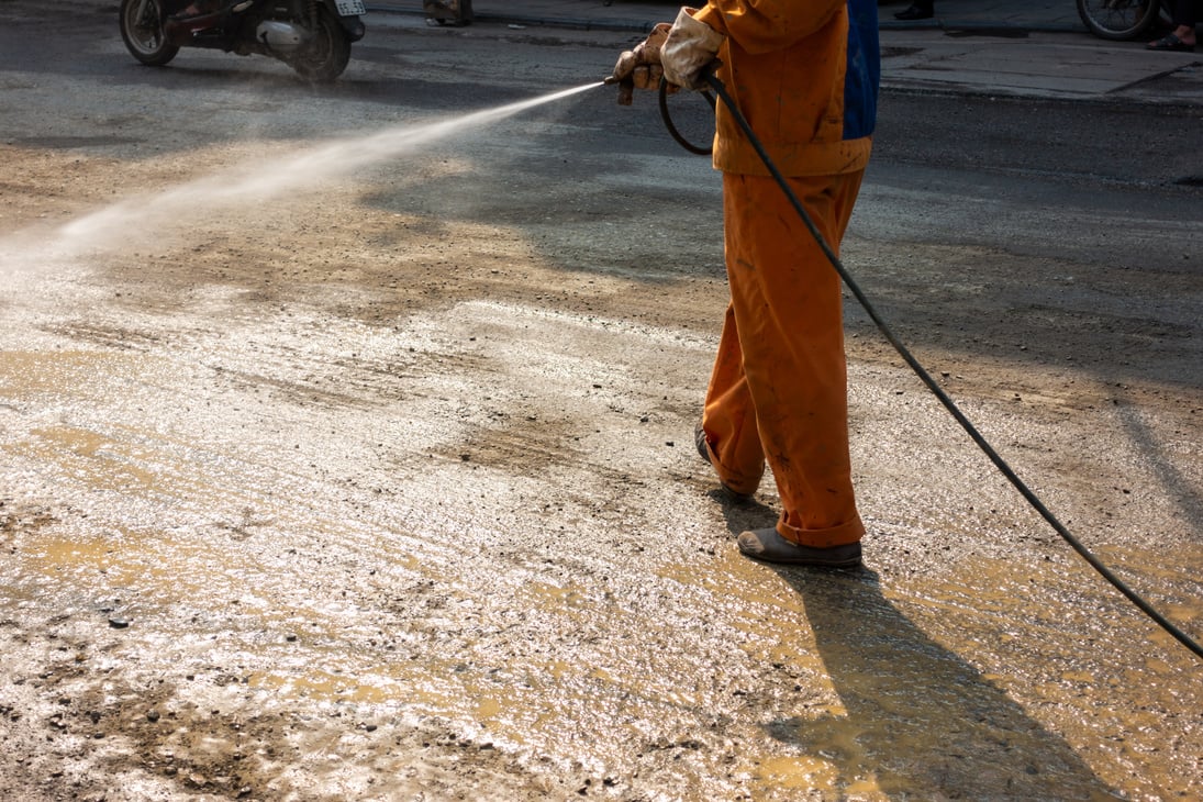 Worker Cleaning Construction Area